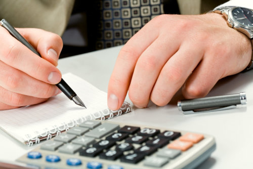 Image of writing instrument in male hands on a workplace