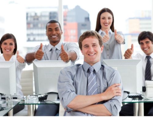 positive business people with thumbs up in the office